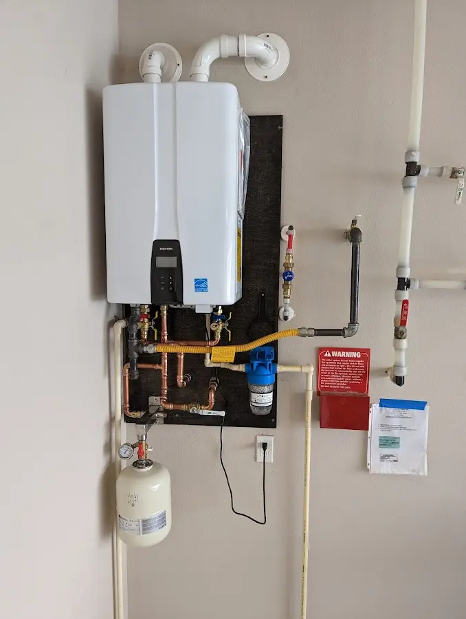 Professional plumber installing copper piping in a The Meadows home